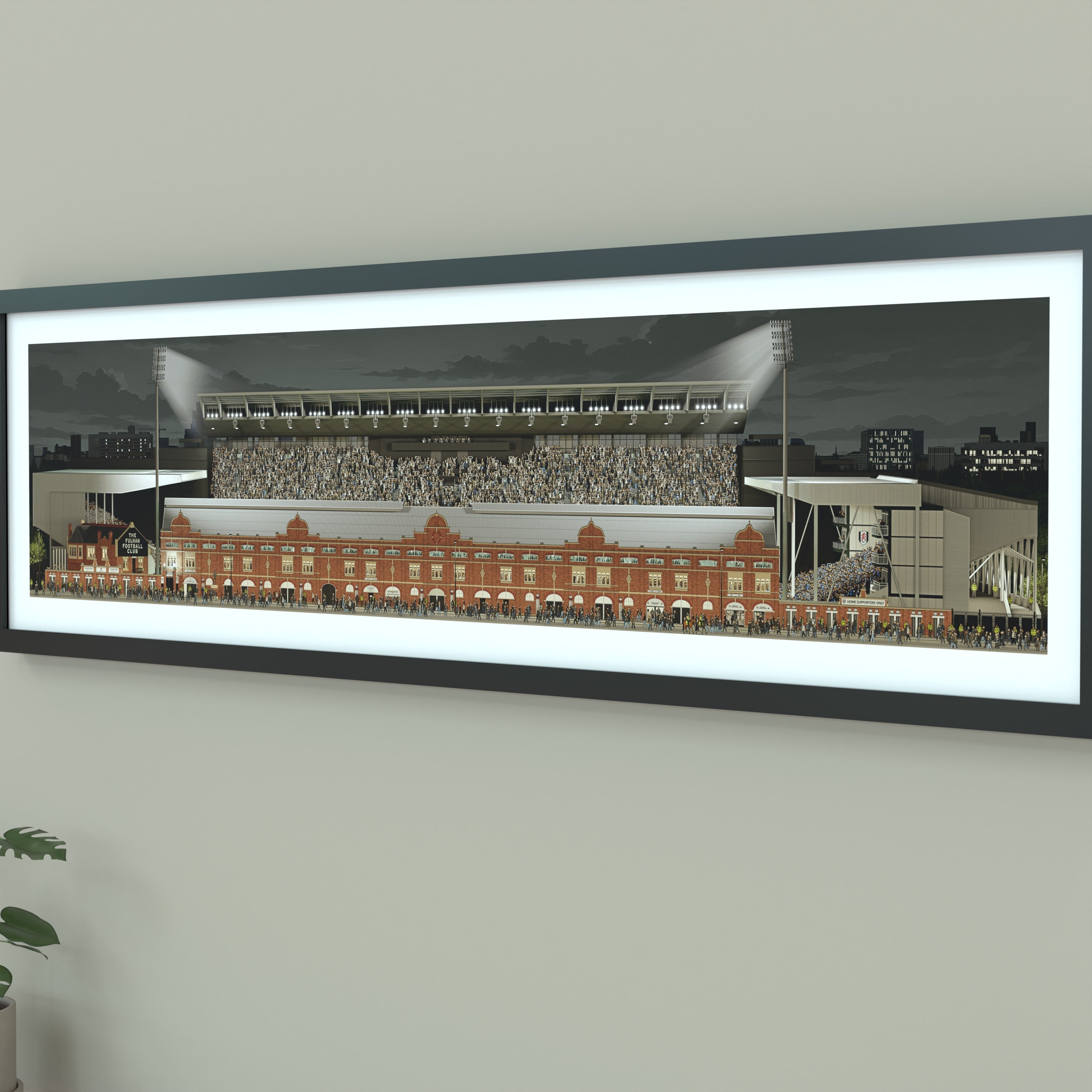 A framed panoramic print of a Fulham's Craven Cottage stadium, displayed on a light gray wall.