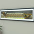 A framed panoramic art print of a Wolves' Molineux stadium, mounted on a light gray wall. The print features a detailed illustration of a stadium filled with yellow and black clad fans under a dark sky.