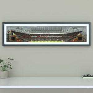 A panoramic cross-sectional illustration of Old Trafford during an FA Cup match, with fans packed in the stands and the pitch under floodlights.